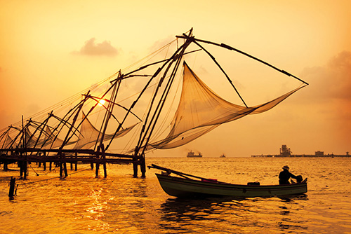 Sunset-over-Chinese-Fishing-nets-and-boat-in-Cochin-Kochi-Kerala-India-shutterstock_1041711291